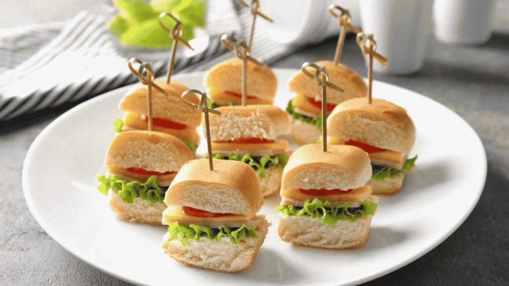 Mini sanduíches com queijo, tomate e alface servidos para assistir aos jogos da Copa do Mundo com amigos e família.